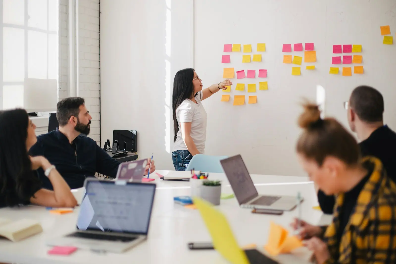 A team brainstorming with sticky notes on a table